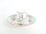 a cup and saucer with a picture of a rabbit on it