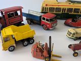 several toy cars and trucks are arranged in a circle on a white surface