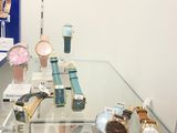 many different watches on display in a glass case