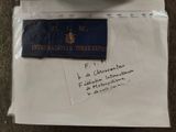 an envelope with a note and a pen on it