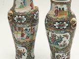 two vases sitting side by side on a white surface