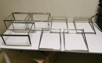 a white table with a bunch of glass boxes on it