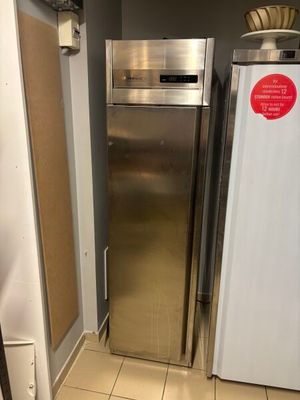a silver refrigerator and a white freezer in a kitchen