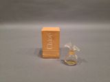 a small bottle of perfume sitting next to a small box