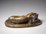 bronze sculpture of a cat laying on its back on a plate
