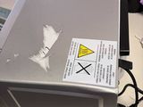 a laptop computer sitting on a table with a sticker on it
