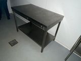 a table with a shelf on it in the corner of a room