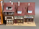 a miniature model of a house with a book on the table
