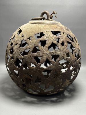 an image of a decorative vase with a bird on top of it