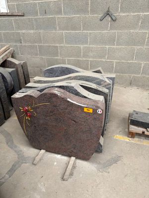 a pile of granite blocks in a room with a brick wall