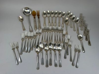 a lot of spoons and forks arranged together on a table