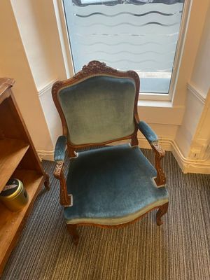 a blue chair in the corner of a room