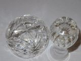 two glass knobs sitting on a white surface
