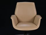 an image of a tan leather office chair against a black background