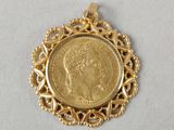 a gold coin pendant with a woman ' s face on it