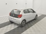 a picture of a small white car parked in a garage