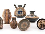 a group of vases and bowls on a white surface