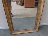 a mirror that is sitting on the floor next to a wall
