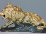 statue of a lion on a rock with its mouth open
