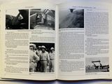 an open book with pictures of military men standing in front of a plane