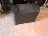 a black speaker that is sitting on the floor