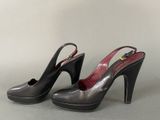 black and silver high heeled shoes with a gold buckle