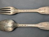 two spoons and a fork on a table