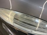 a close up of a car ' s headlight with a blurry background