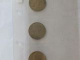 three coins in a clear plastic bag on a table