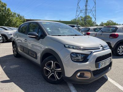 une Citroën argentée garée sur un parking à côté d'autres voitures
