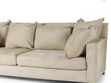 an image of a beige couch with pillows on it
