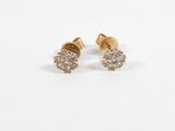 a pair of diamond stud earrings on a white background