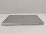 an open laptop computer sitting on top of a white table