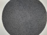 a gray round object on a white surface