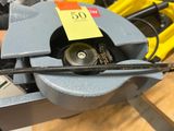 a small machine that is being used to cut a piece of metal