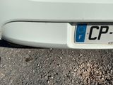 a close up of a license plate on a white car