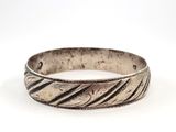a close up of a silver ring on a white surface