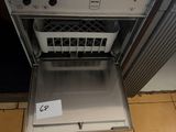 a dishwasher that is open on the floor