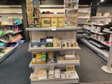 many shelves in the store that have books on them