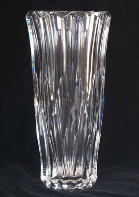a glass vase that is sitting on a black surface