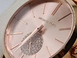 a rose gold watch with a diamond dial on the face