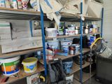 a room with several shelves and buckets of paint on it