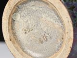 a close up of a vase on a table