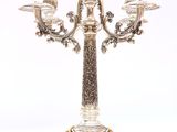 a silver candelab with four candles on top of it