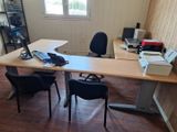 a desk with two chairs and a computer on it