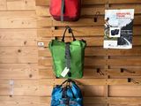 three bags hanging on the wall in the store