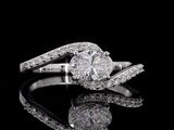 a picture of a diamond ring on a reflective surface