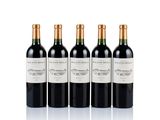 three bottles of wine are lined up on a white surface