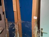 une photo d'une salle de bains avec des toilettes et une porte bleue
