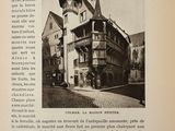 a black and white photo of a building with a clock on it